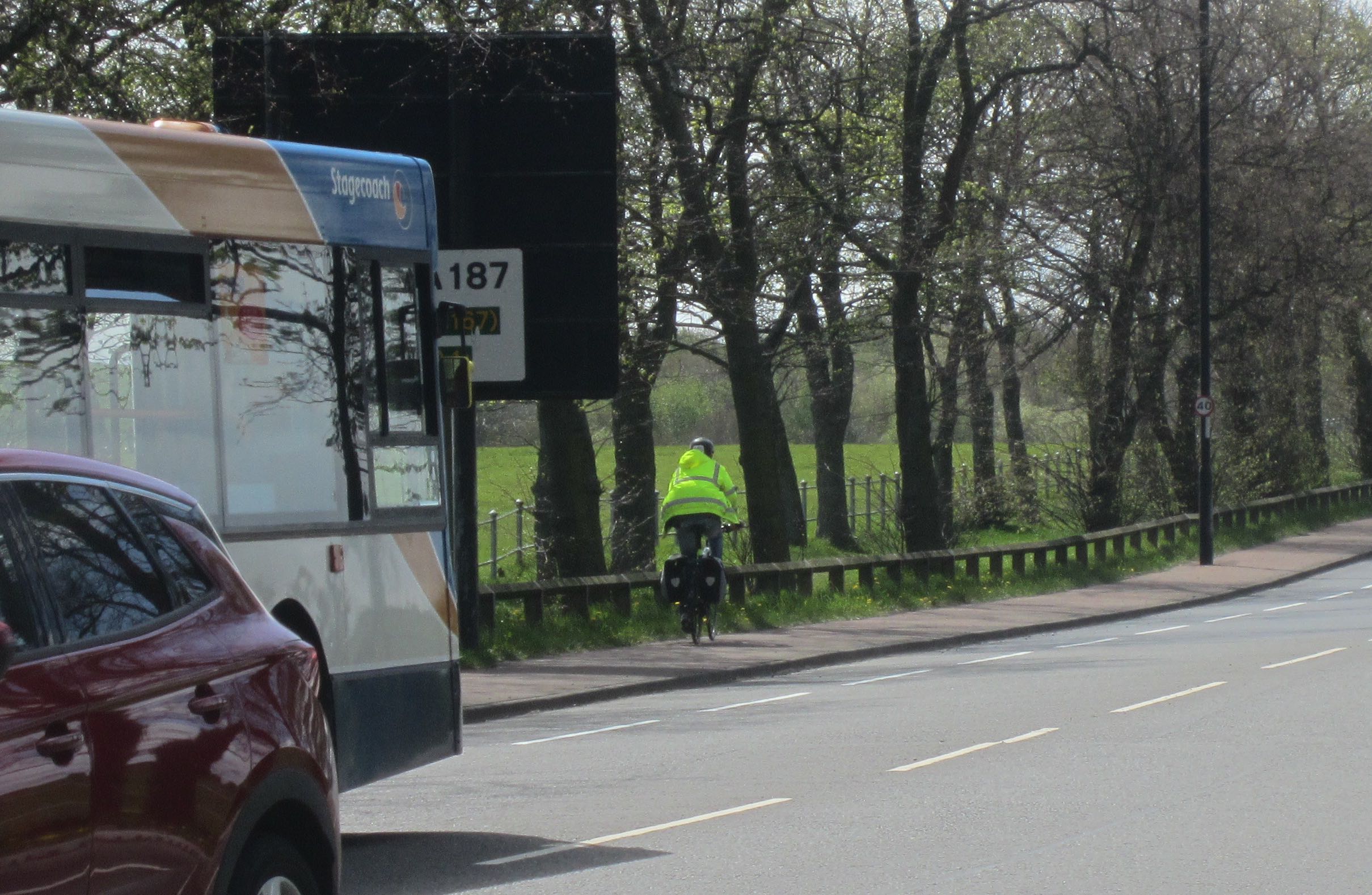Person cycling towards Cow Hill on the pavement next to the Town Moor
