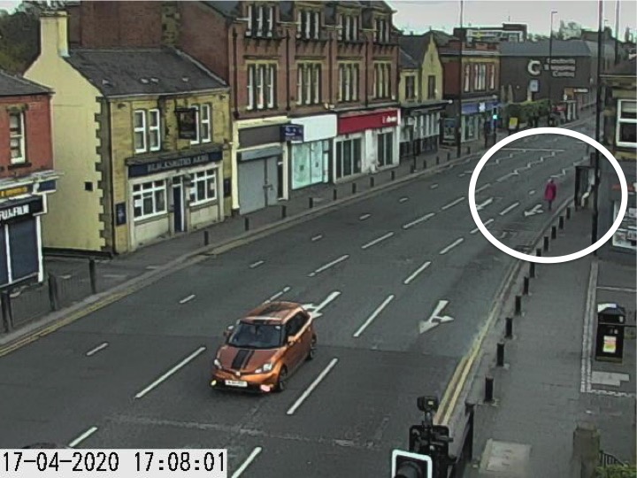 Traffic camera picture of Gosforth High Street with someone walking in the road.