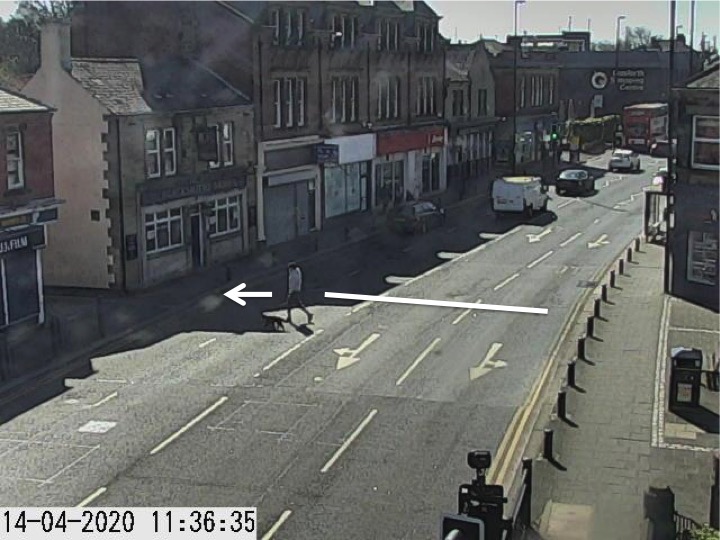 Traffic camera picture of Gosforth High Street with someone crossing the road.