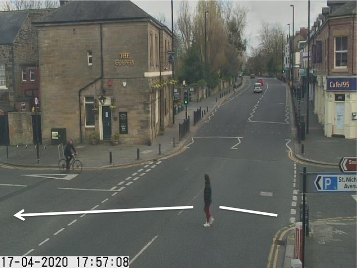 Traffic camera picture of Gosforth High Street with someone crossing the road.