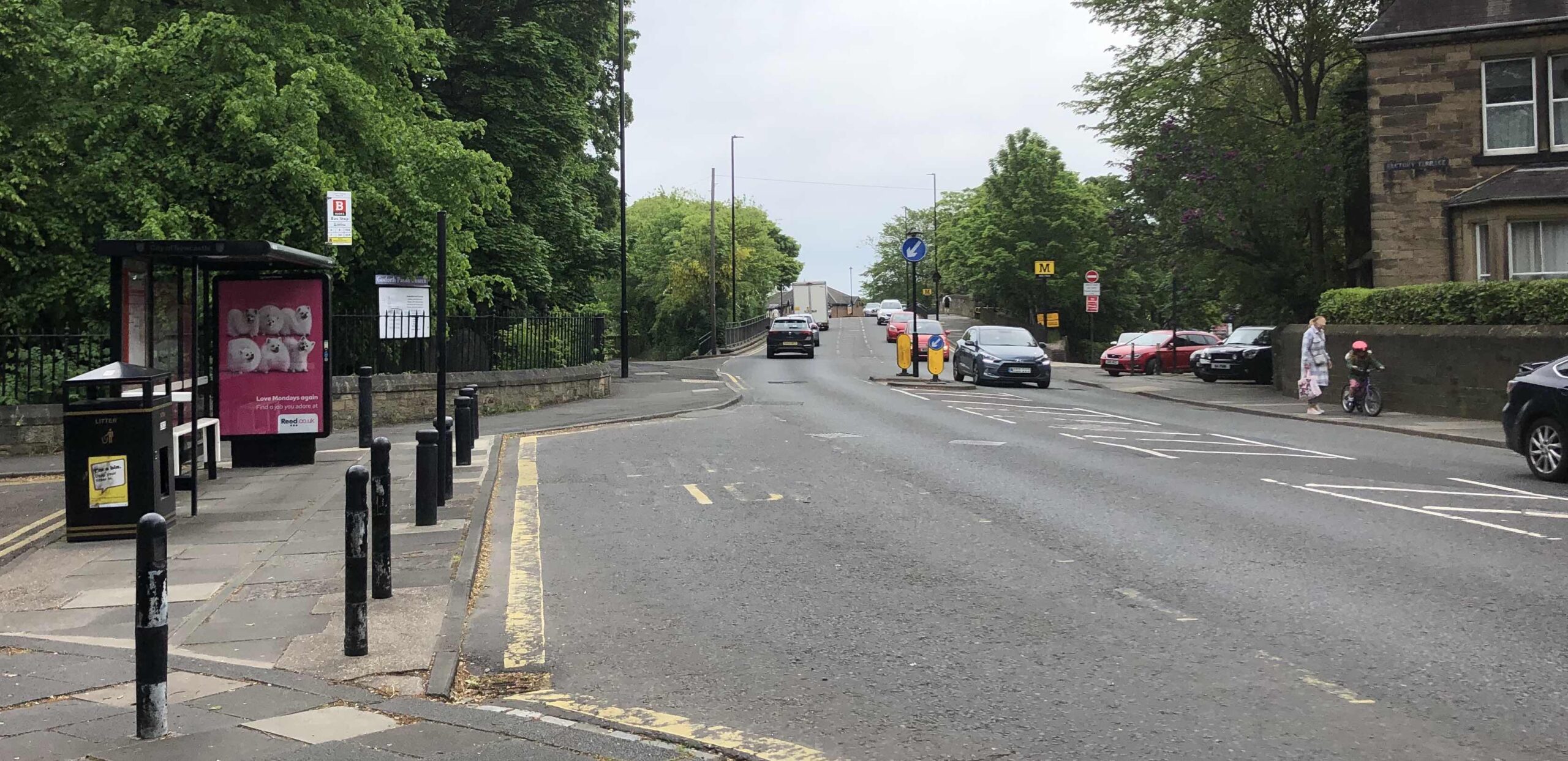 Picture of Station Road looking towards South Gosforth Metro. On the left is a bus stop over the end of Church Road that prevents vehicles entering or exiting. 