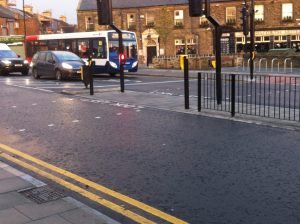 salters road crossing looking across towards the gosforth hotel. showing the pedestrian refuge in the middle of the road and vehicles queing at the traffic lights