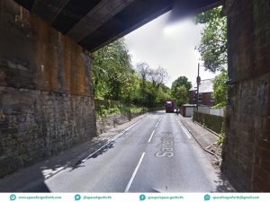 Picture showing the Killingworth Road Metro bridge with a narrow pavement on the left (east side) and no pavement on the right.