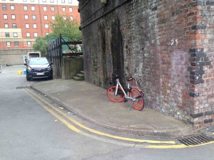 Picture of a Mobike parked under a railway bridge