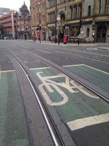 Picture of a bicycle advanced stop box with tram lines going through the middle that bike tires could get caught in.