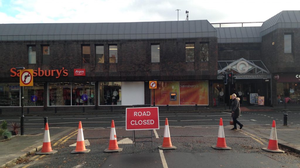 Picture of the junction of Ivy Road and the High Street, with cones across the end of Ivy Road.