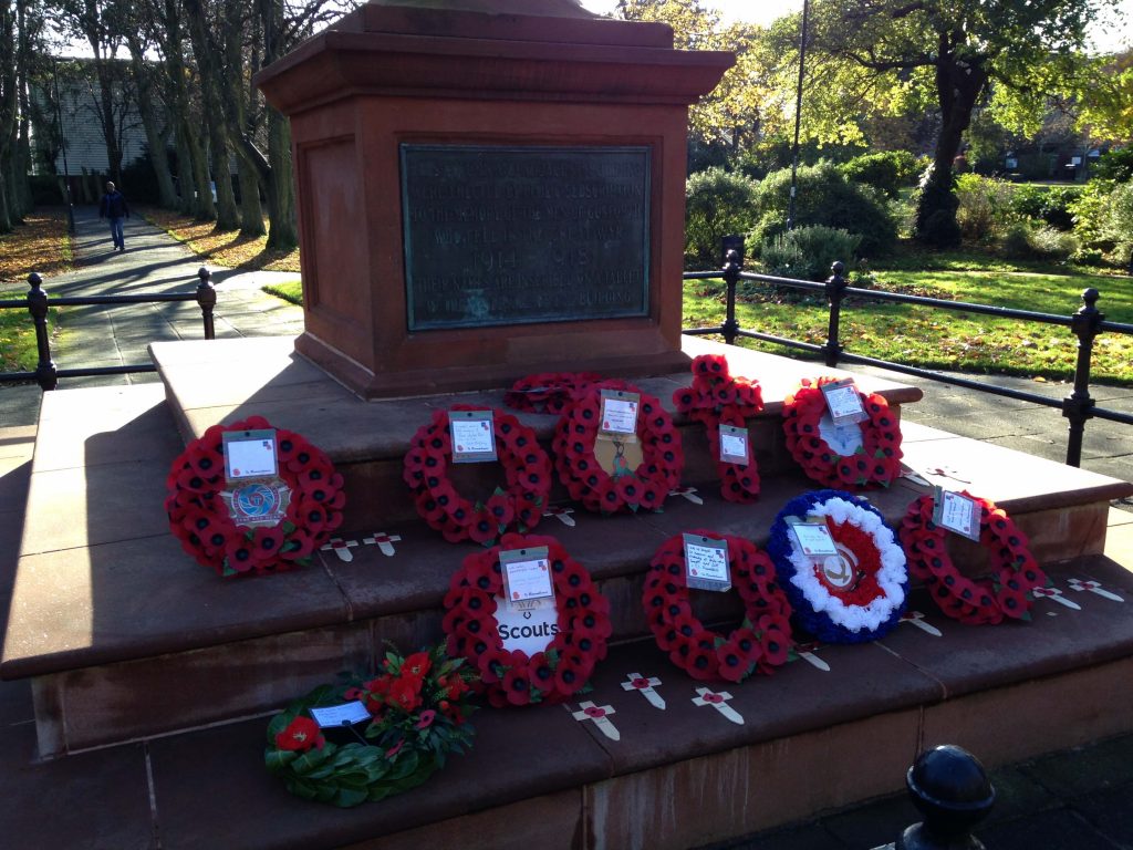 Picture of the Gosforth Central Park War Memorial including wreaths placed on Remembrance Day