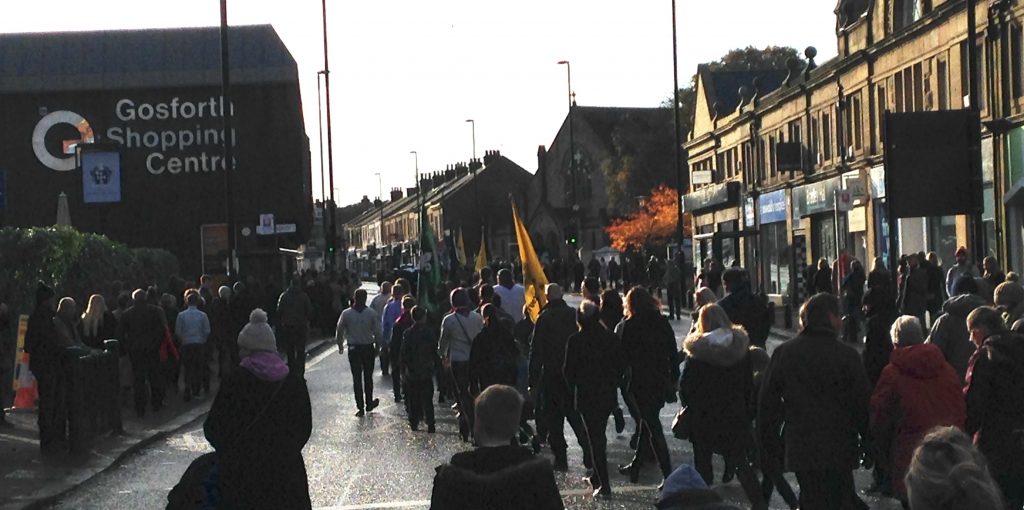 Picture of the Remembrance Sunday parade on Gosforth High Street heading towards Gosforth Central Park. 