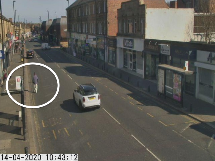 Traffic camera picture of Gosforth High Street with someone walking in the road.