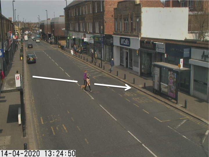 Traffic camera picture of Gosforth High Street with someone crossing the road.