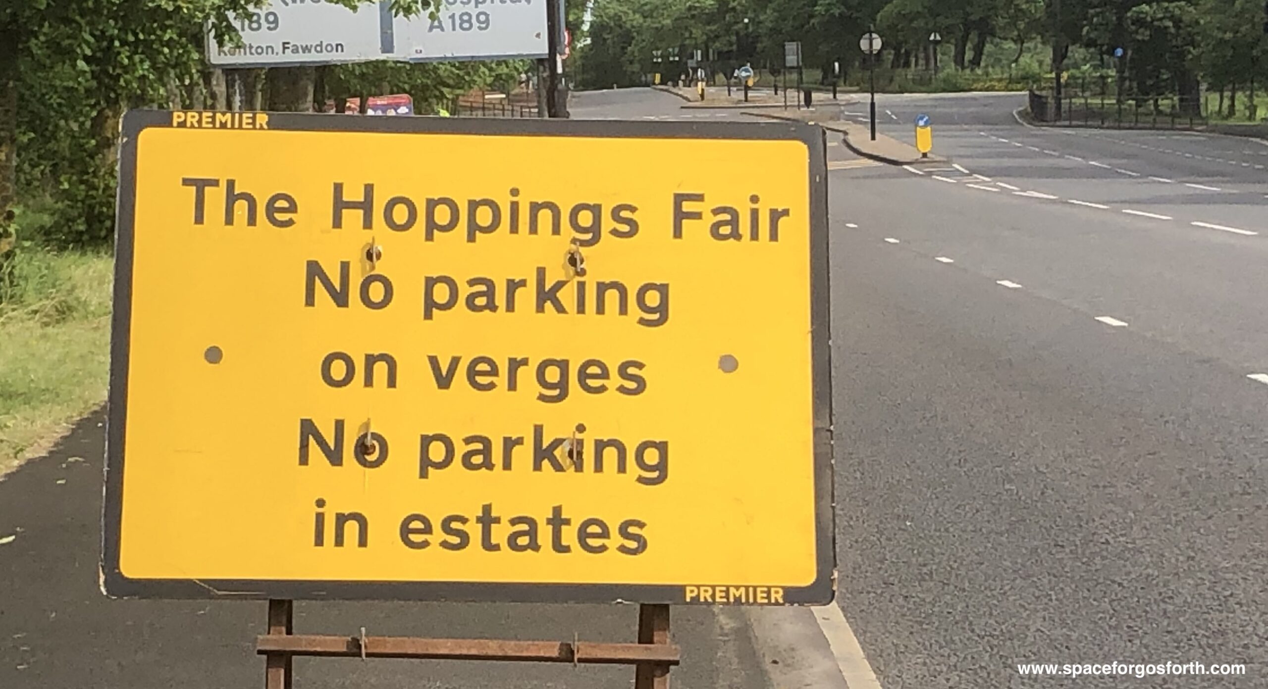 Road sign: The Hoppings Fair. No parking on verges. No parking in estates.