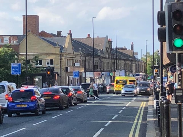 Picture of Gosforth High Street showing the south bound cycle lane next to Gosforth Shopping Centre